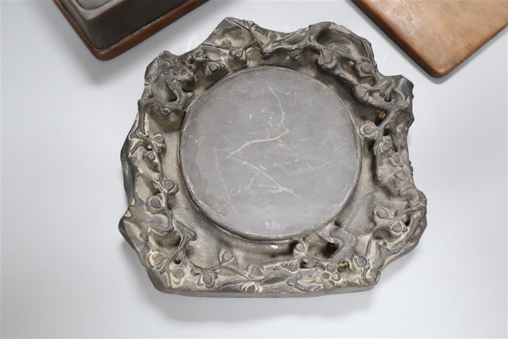 A 19th century Chinese black slate inkstone and another with wood base and cover